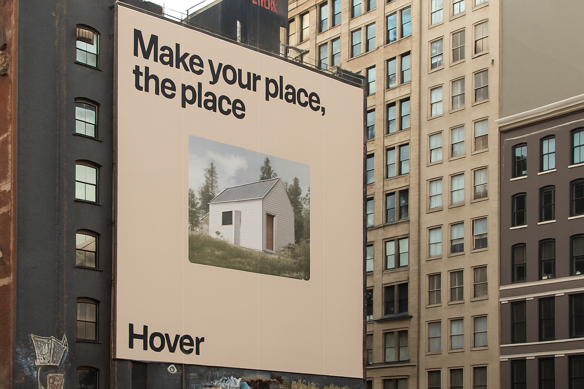 An image of a square billboard on an urban high-rise. It says “Make your place, the place” with the Hover logo. The center of the billboard shows a small one-story white house.
